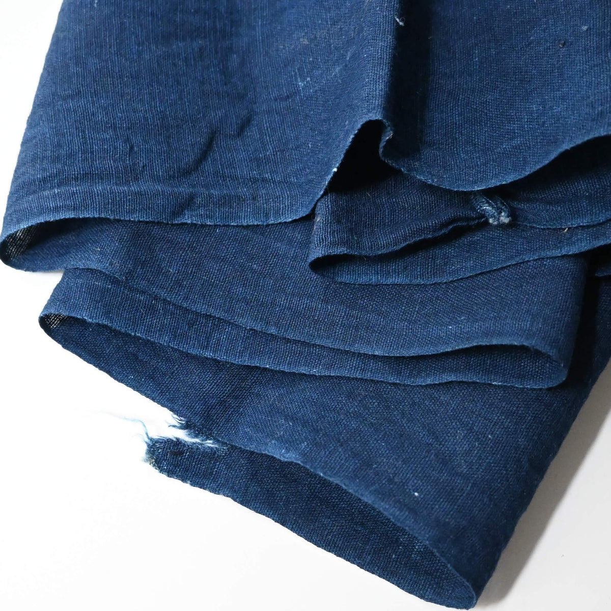 Close-up view of vintage Japanese slightly open weave cotton dyed in deep indigo blue.