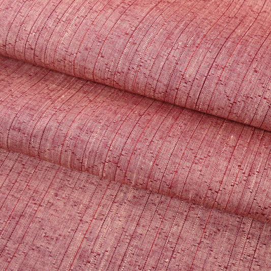 Close-up view of vintage dusty pink tsumugi silk kimono fabric sold by the metre.