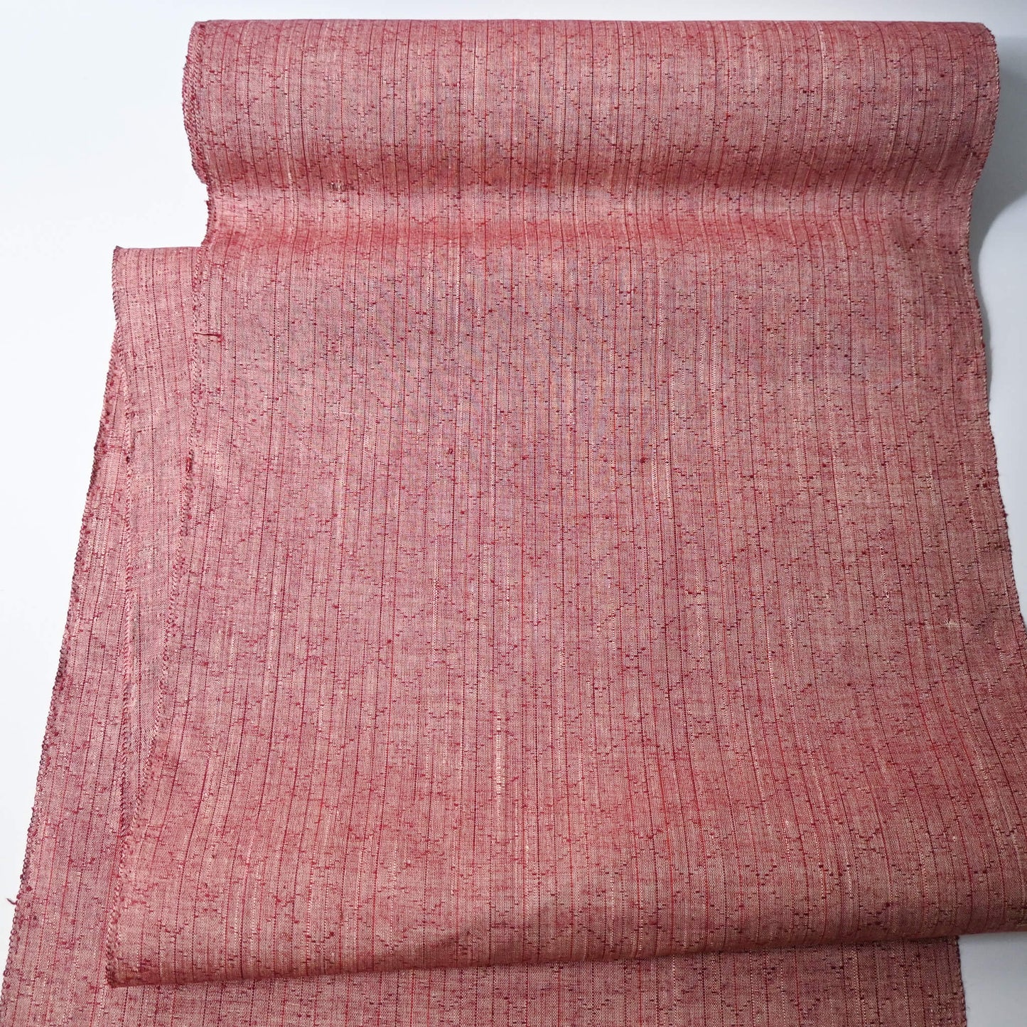 Full view of vintage dusty pink tsumugi silk kimono fabric sold by the metre.