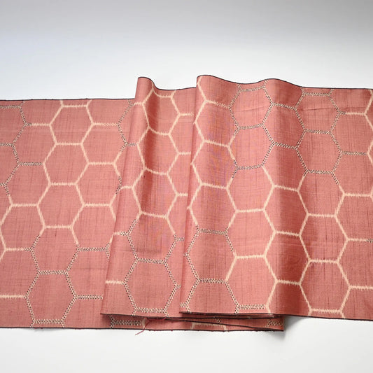 Full view of vintage Japanese dusty pink tsumugi silk kimono fabric with tortoise shell motif.