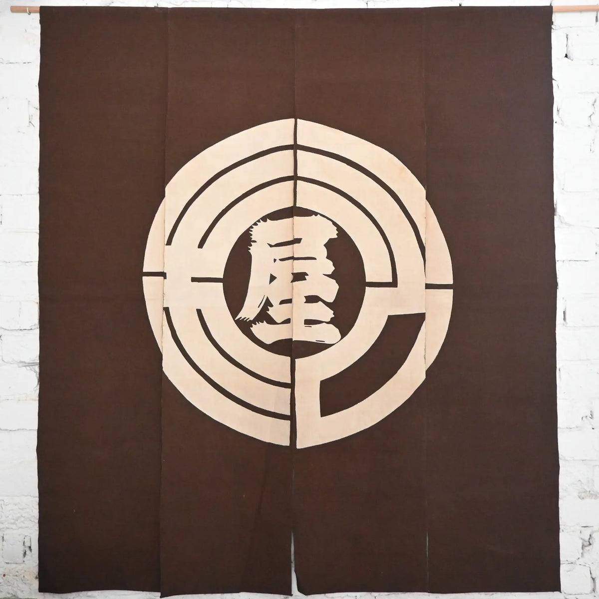 Vintage four-panel brown cotton shop noren with a bold logo from mid-20th Century.