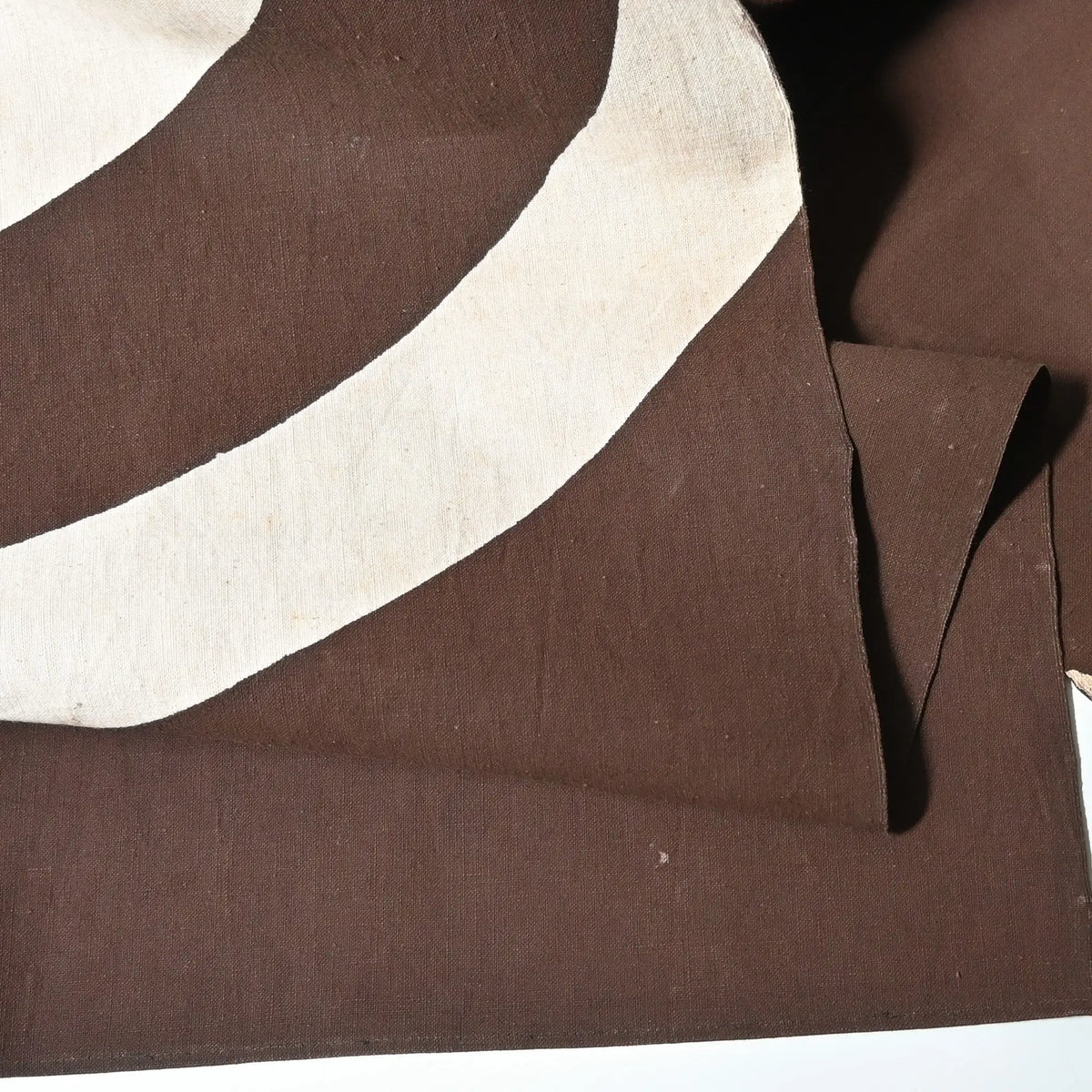 Detailed view of vintage four-panel brown cotton shop noren with a bold logo from mid-20th Century.