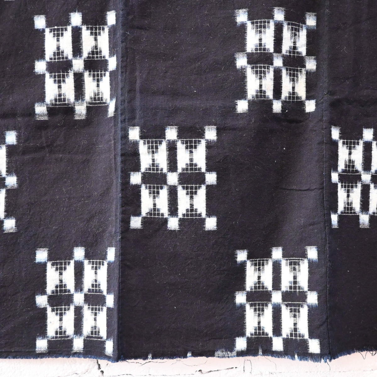 Detailed view of vintage four-panel indigo egasuri cotton futon cover.