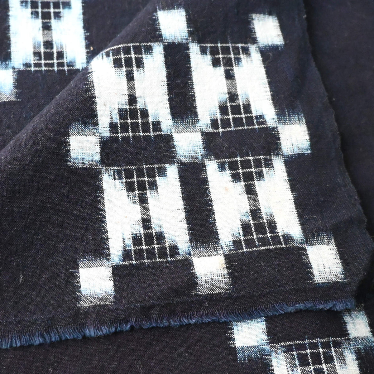 Detailed view of vintage four-panel indigo egasuri cotton futon cover.