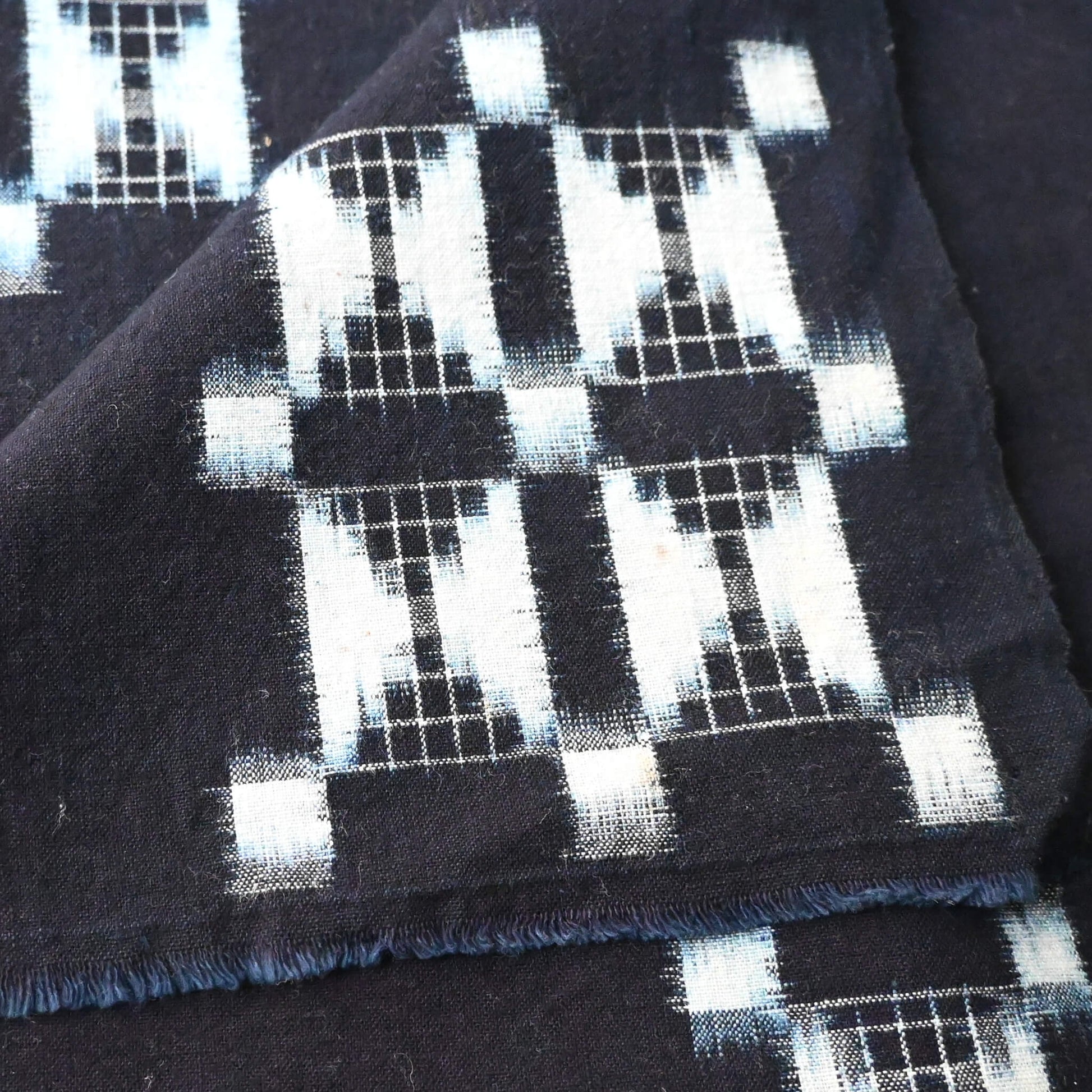 Detailed view of vintage four-panel indigo egasuri cotton futon cover.