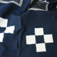Close-up view of vintage Japanese four-panel indigo kasuri cotton futon cover with a bold geometric design.