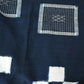 Close-up view of vintage Japanese four-panel indigo kasuri cotton futon cover with a bold geometric design.