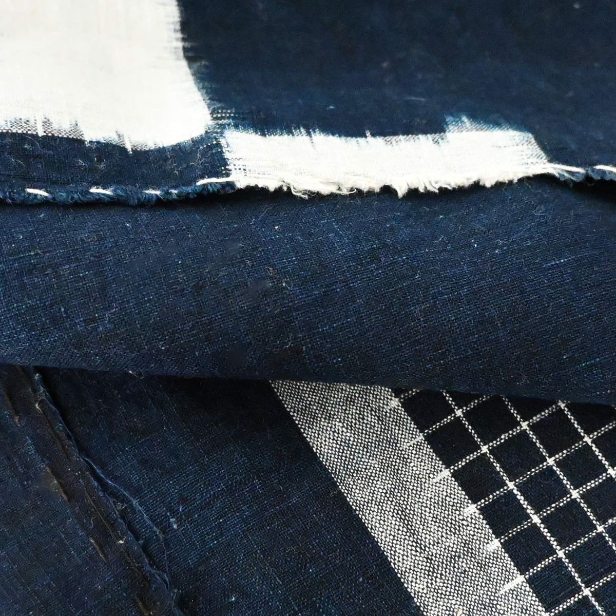 Close-up view of vintage Japanese four-panel indigo kasuri cotton futon cover with a bold geometric design.