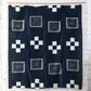 Vintage Japanese four-panel indigo kasuri cotton futon cover with a bold geometric design.