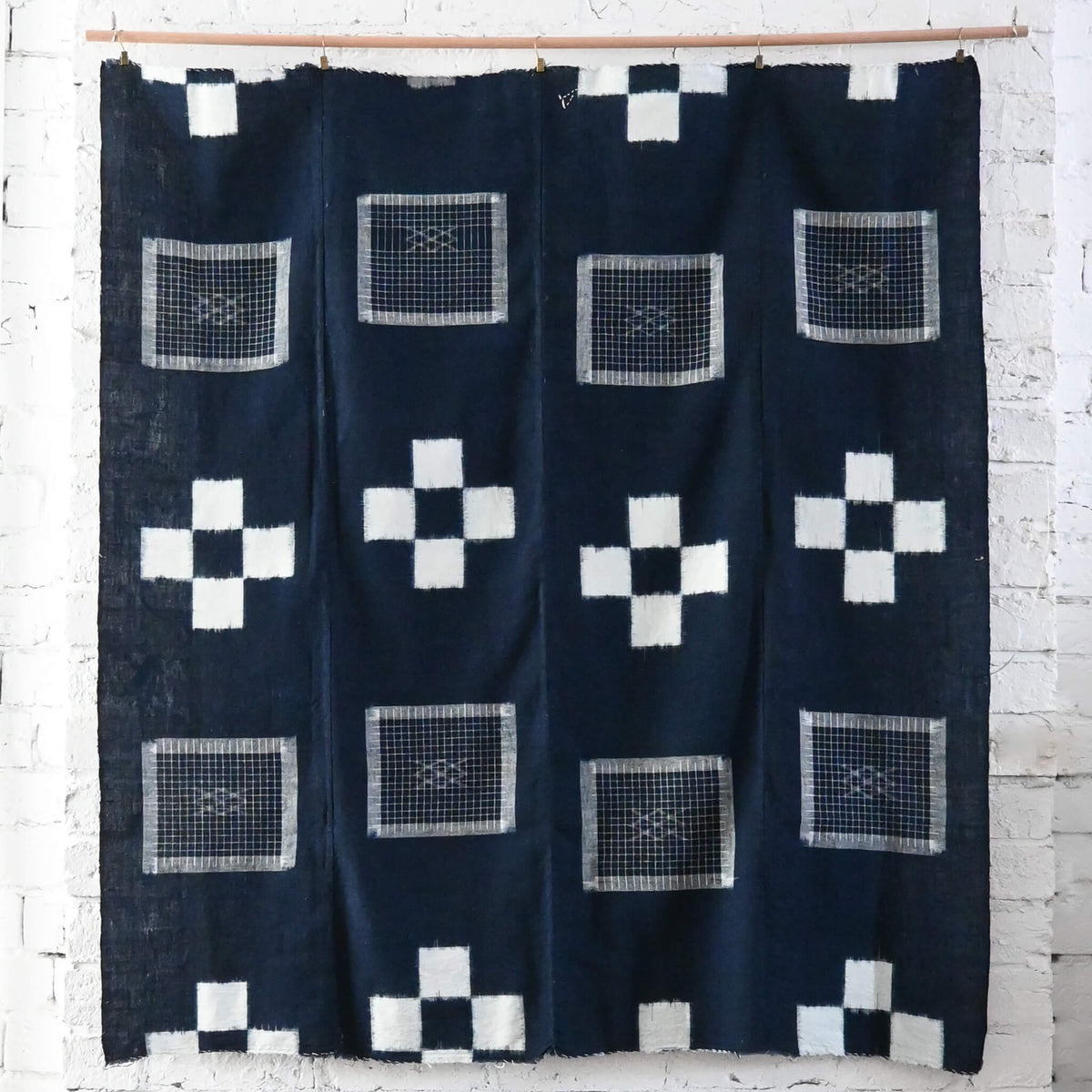 Vintage Japanese four-panel indigo kasuri cotton futon cover with a bold geometric design.
