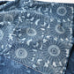Close-up view of vintage four-panel indigo katazome dyed cotton futon cover with chrysanthemum arabesque motif.