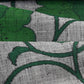 Close-up view of vintage Japanese grey tsumugi silk kimono fabric with deep green large-scale floral design.