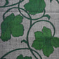 Close-up view of vintage Japanese grey tsumugi silk kimono fabric with deep green large-scale floral design.