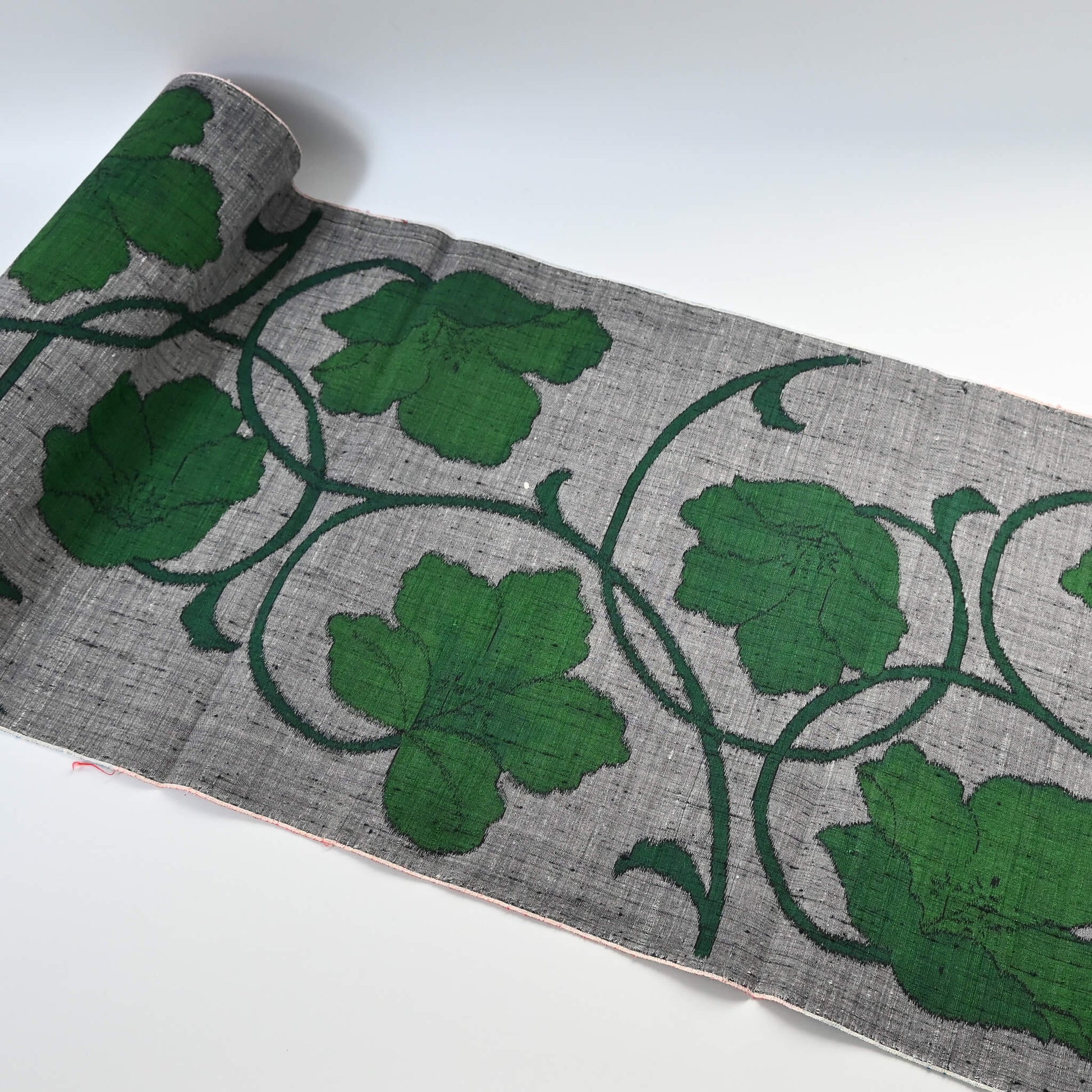 Vintage Japanese grey tsumugi silk kimono fabric with deep green large-scale floral design, sold by the metre.