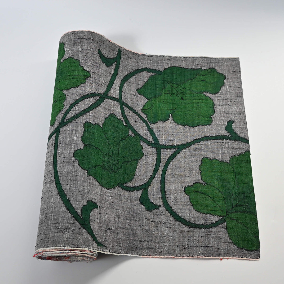 Vintage Japanese grey tsumugi silk kimono fabric with deep green large-scale floral design, sold by the metre.