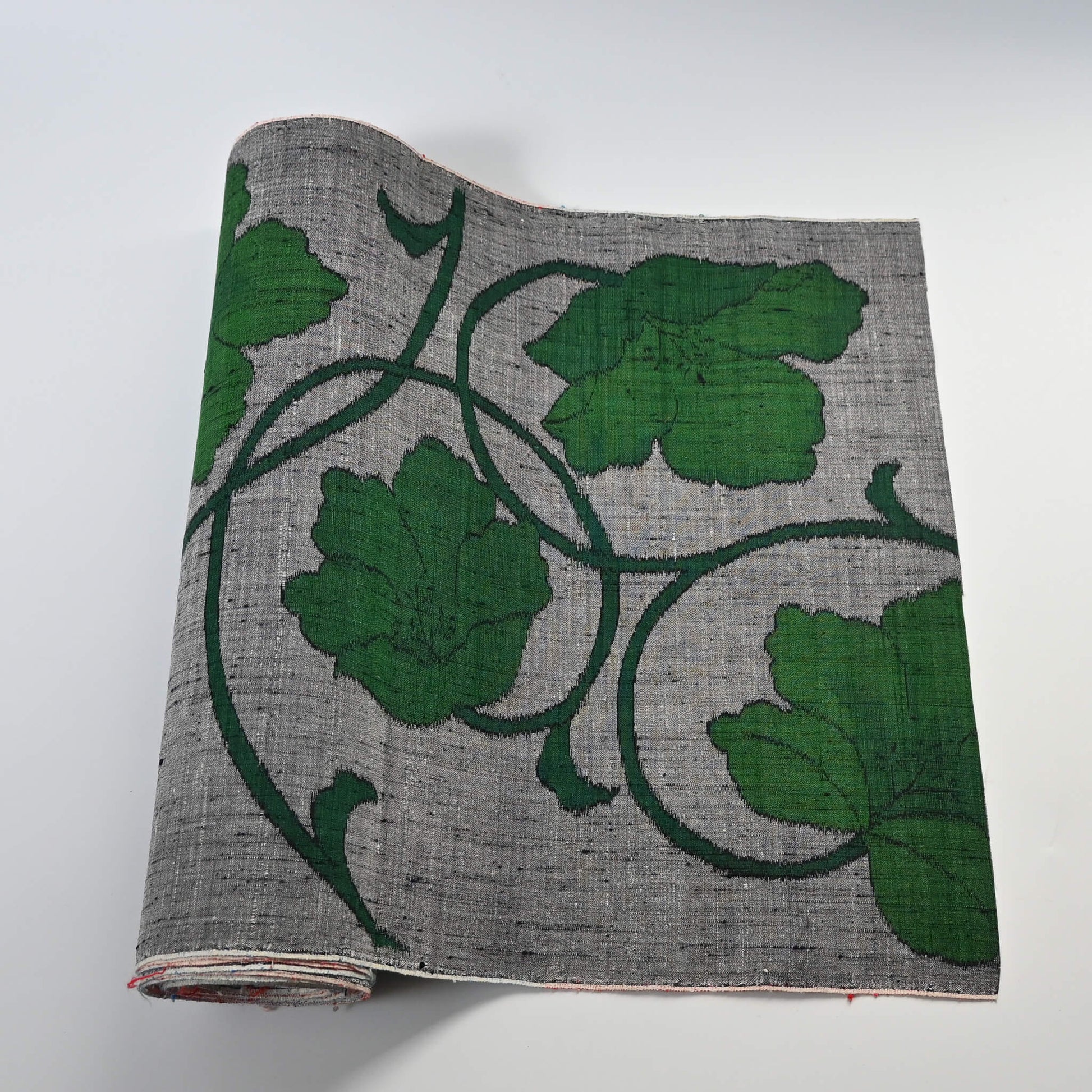 Vintage Japanese grey tsumugi silk kimono fabric with deep green large-scale floral design, sold by the metre.