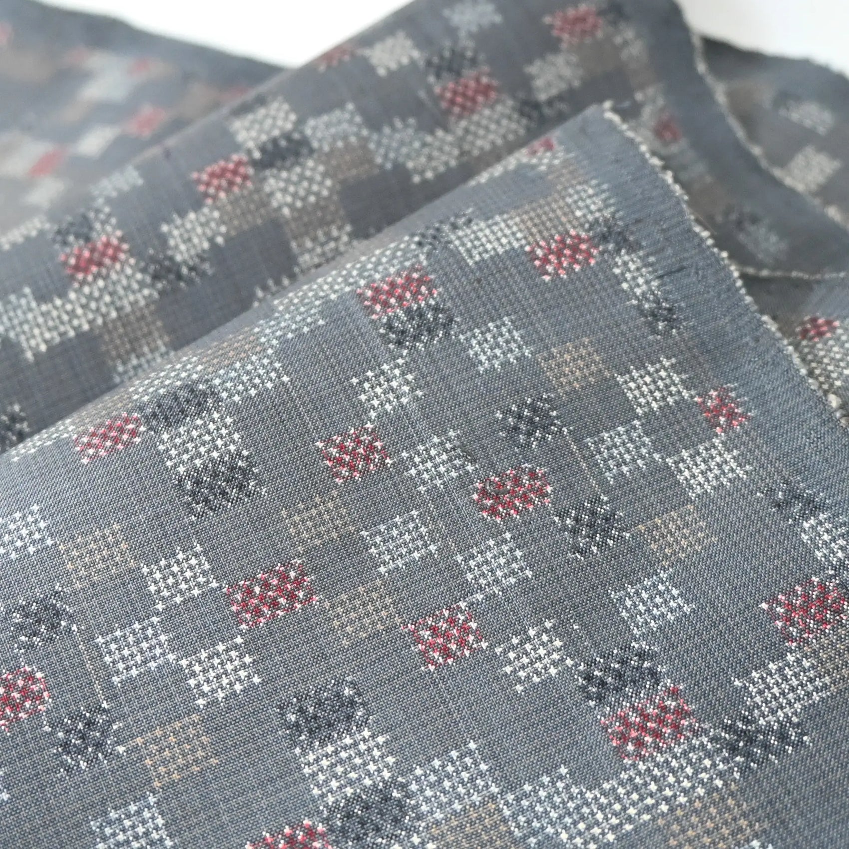 Detailed view of vintage silk kimono fabric in green grey with a charming check pattern.