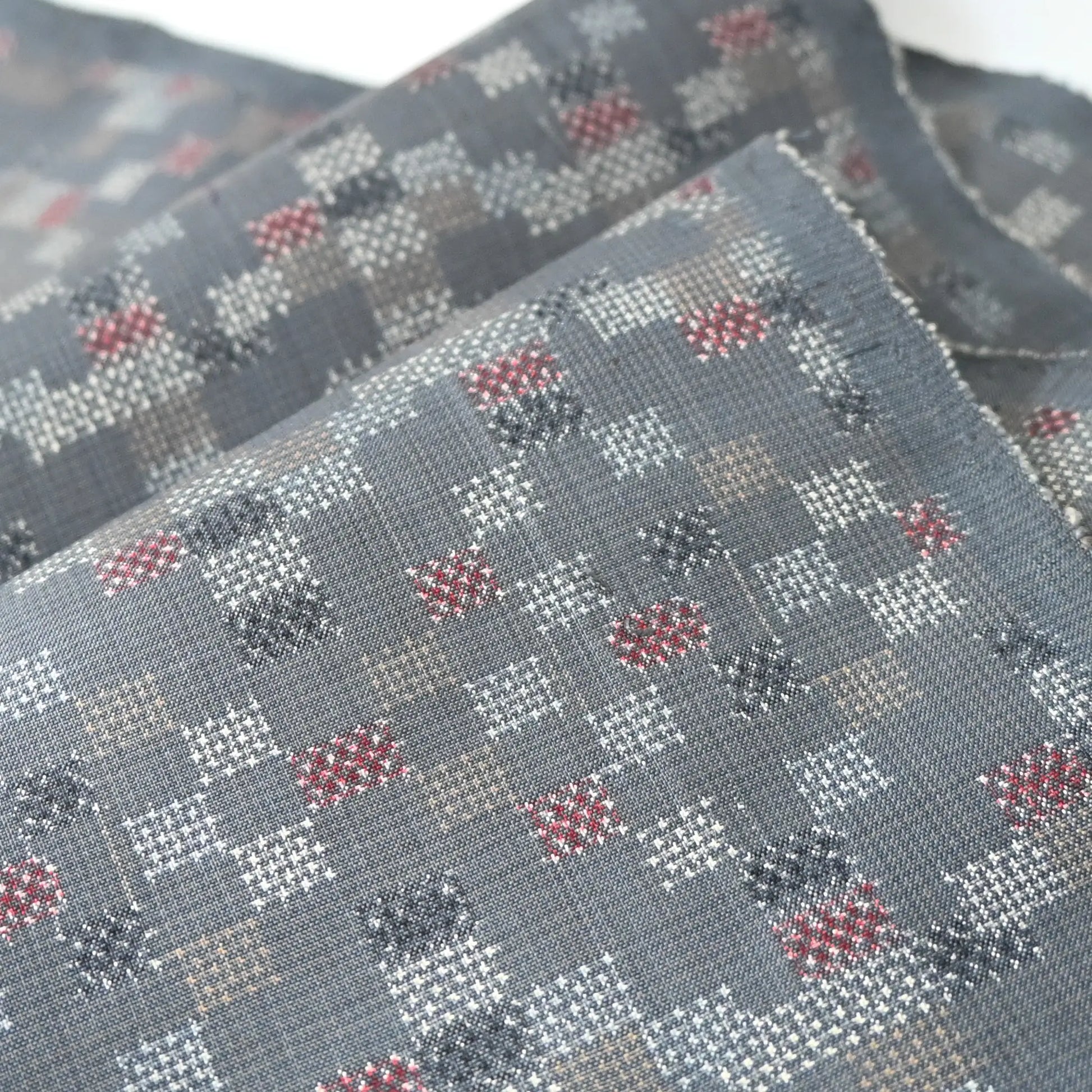 Detailed view of vintage silk kimono fabric in green grey with a charming check pattern.