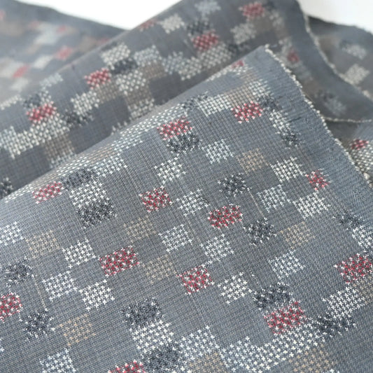 Detailed view of vintage silk kimono fabric in green grey with a charming check pattern.