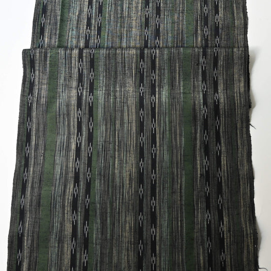 Full view of vintage tsumugi silk kimono fabric with olive green, charcoal and black stripes, and kasuri accents.