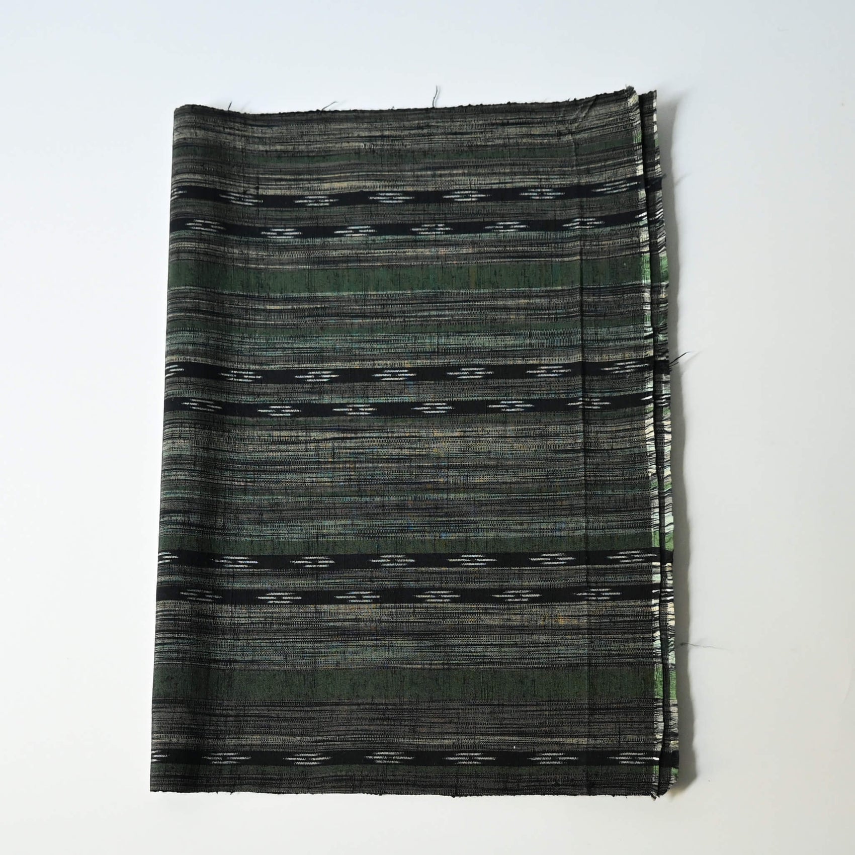 Vintage tsumugi silk kimono fabric with olive green, charcoal and black stripes, and kasuri accents.