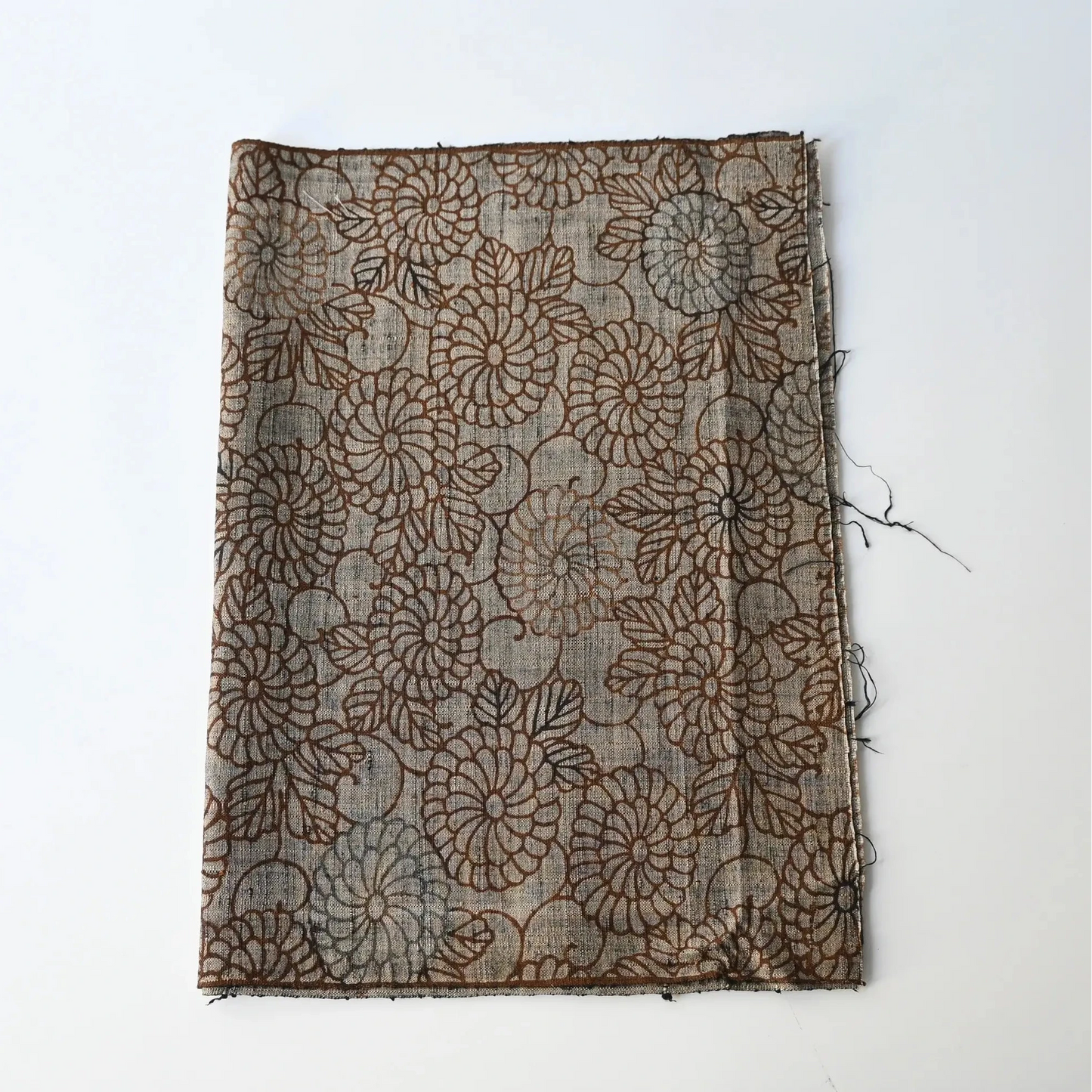 Vintage tsumugi silk kimono fabric in earthy greige colour with brown chrysanthemum motif.