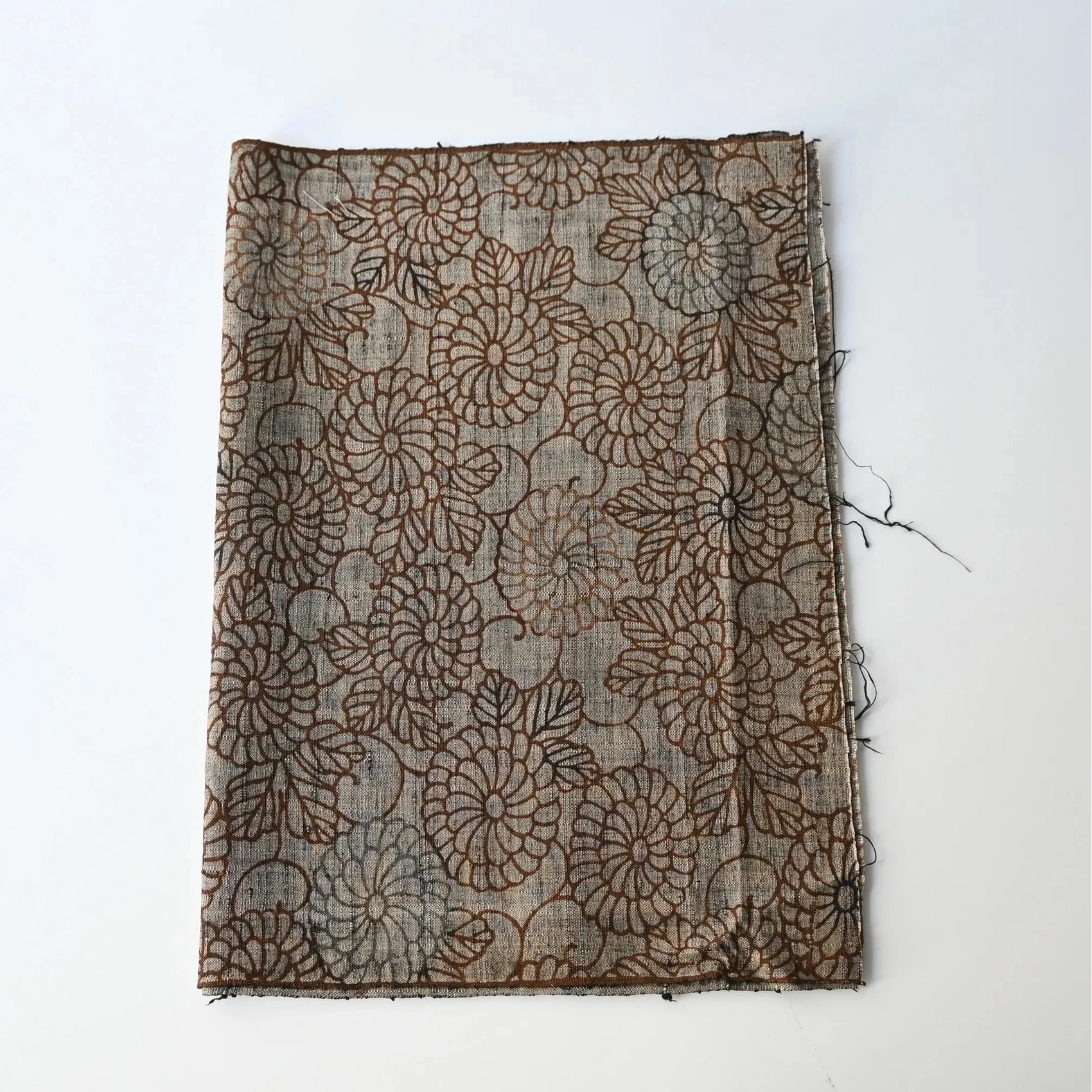 Vintage tsumugi silk kimono fabric in earthy greige colour with brown chrysanthemum motif.