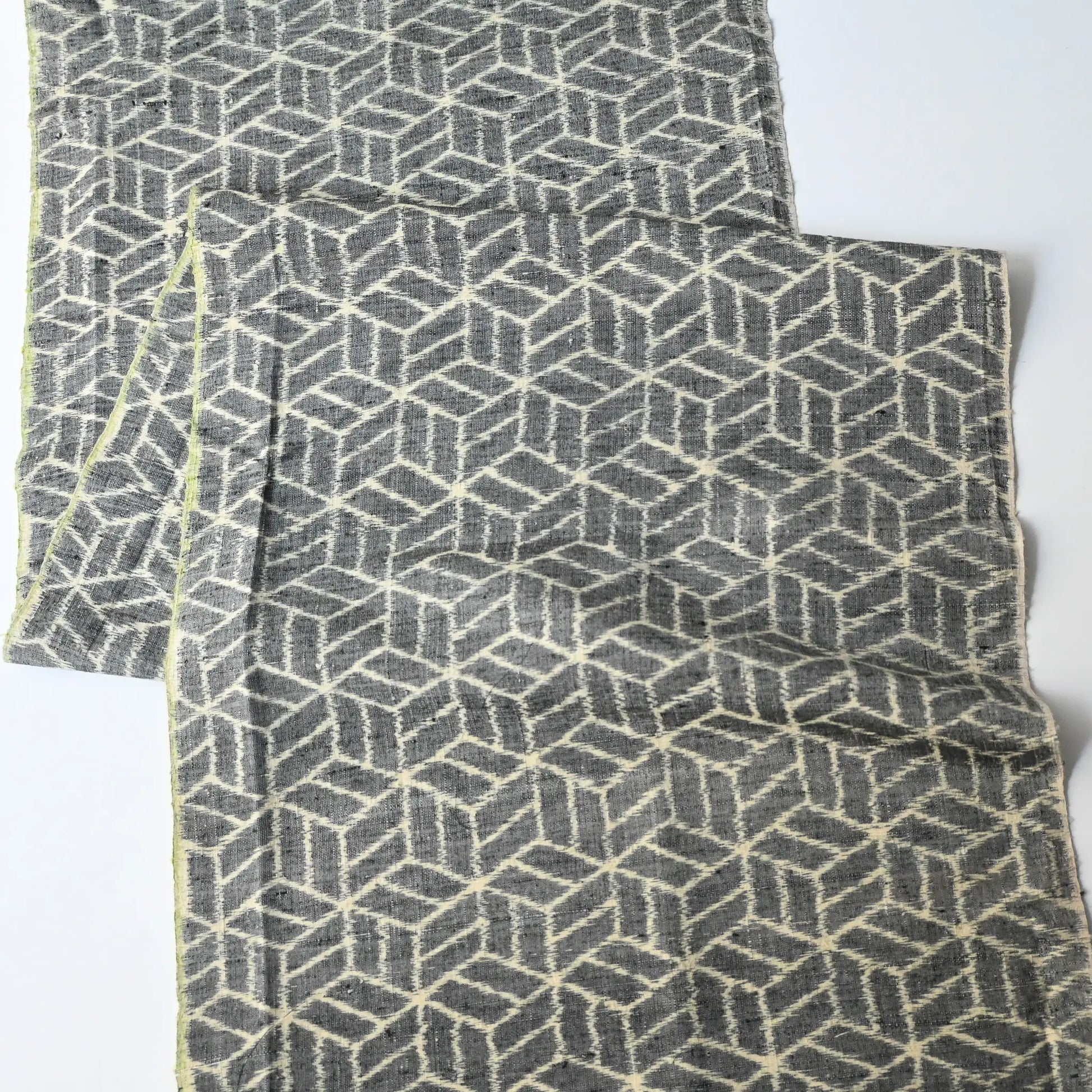Full view of vintage grey tsumugi kimono silk with geometric pattern.