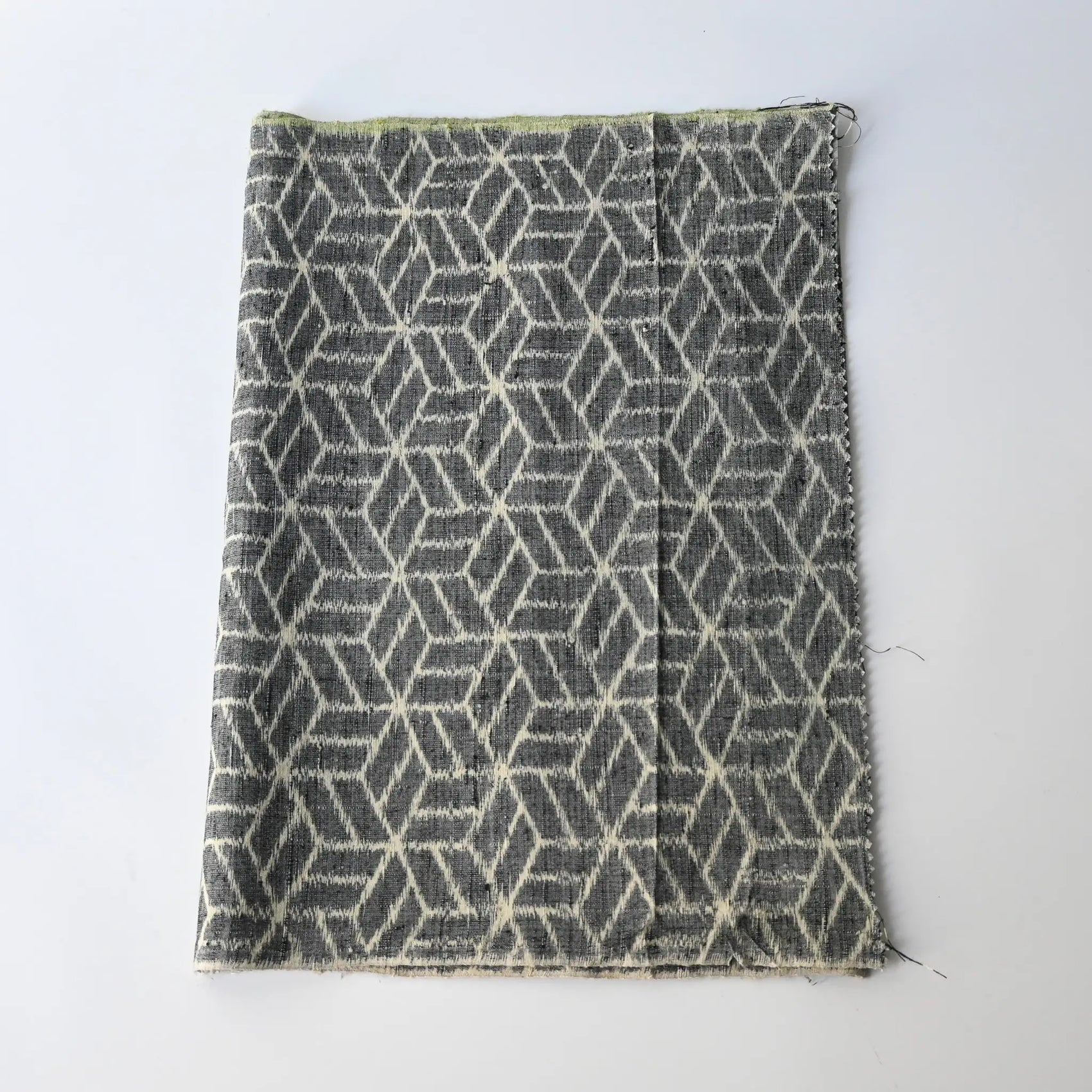 Vintage grey tsumugi kimono silk with geometric pattern, natural slubs.