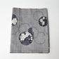Vintage grey tsumugi silk kimono fabric piece with floral pattern.