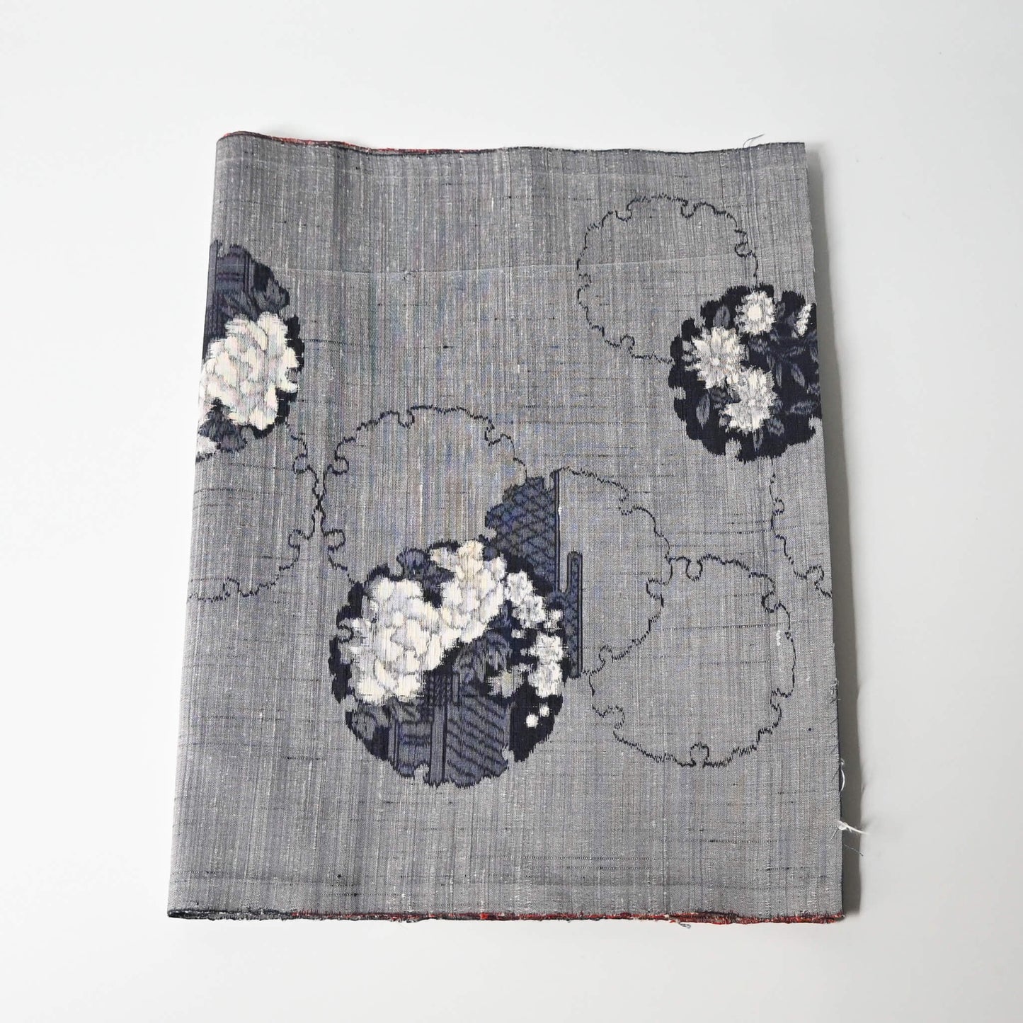 Vintage grey tsumugi silk kimono fabric piece with floral pattern.