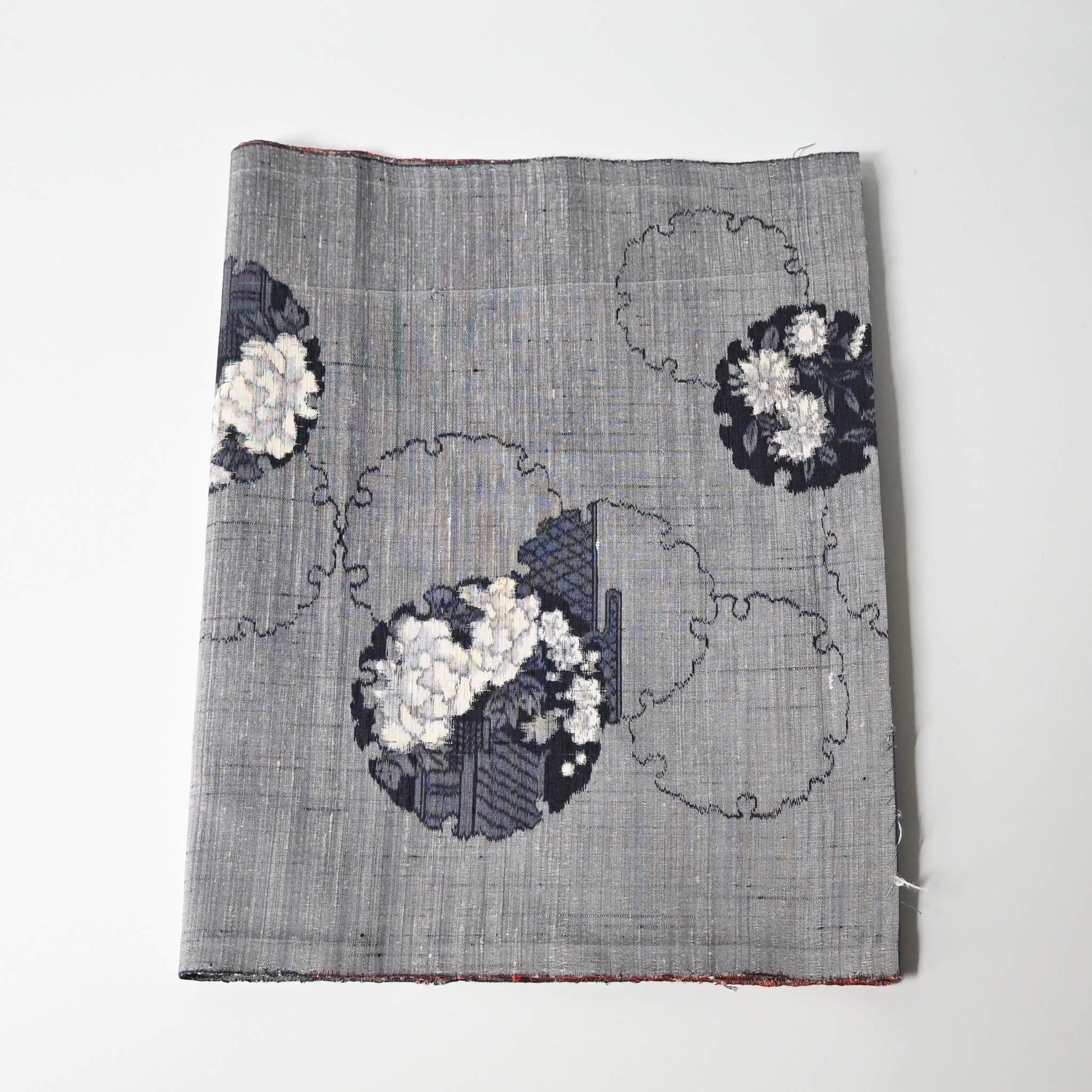 Vintage grey tsumugi silk kimono fabric piece with floral pattern.
