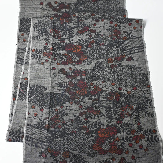 Full view of vintage grey tsumugi silk kimono fabric, garden with flower design.