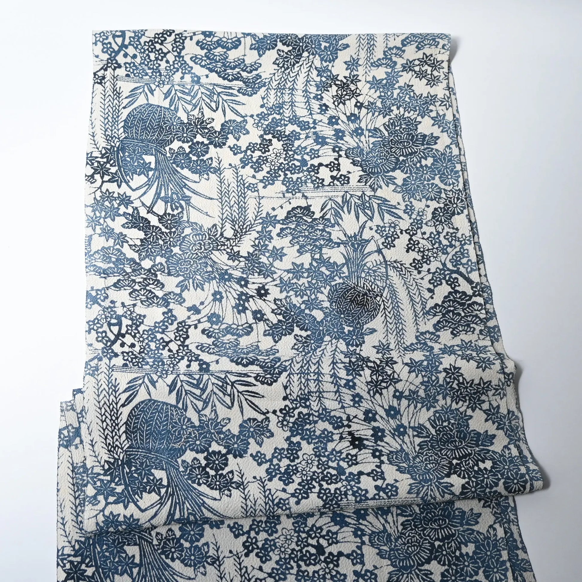 full view of vintage heavy silk crepe Chirimen kimono fabric with indigo floral pattern.