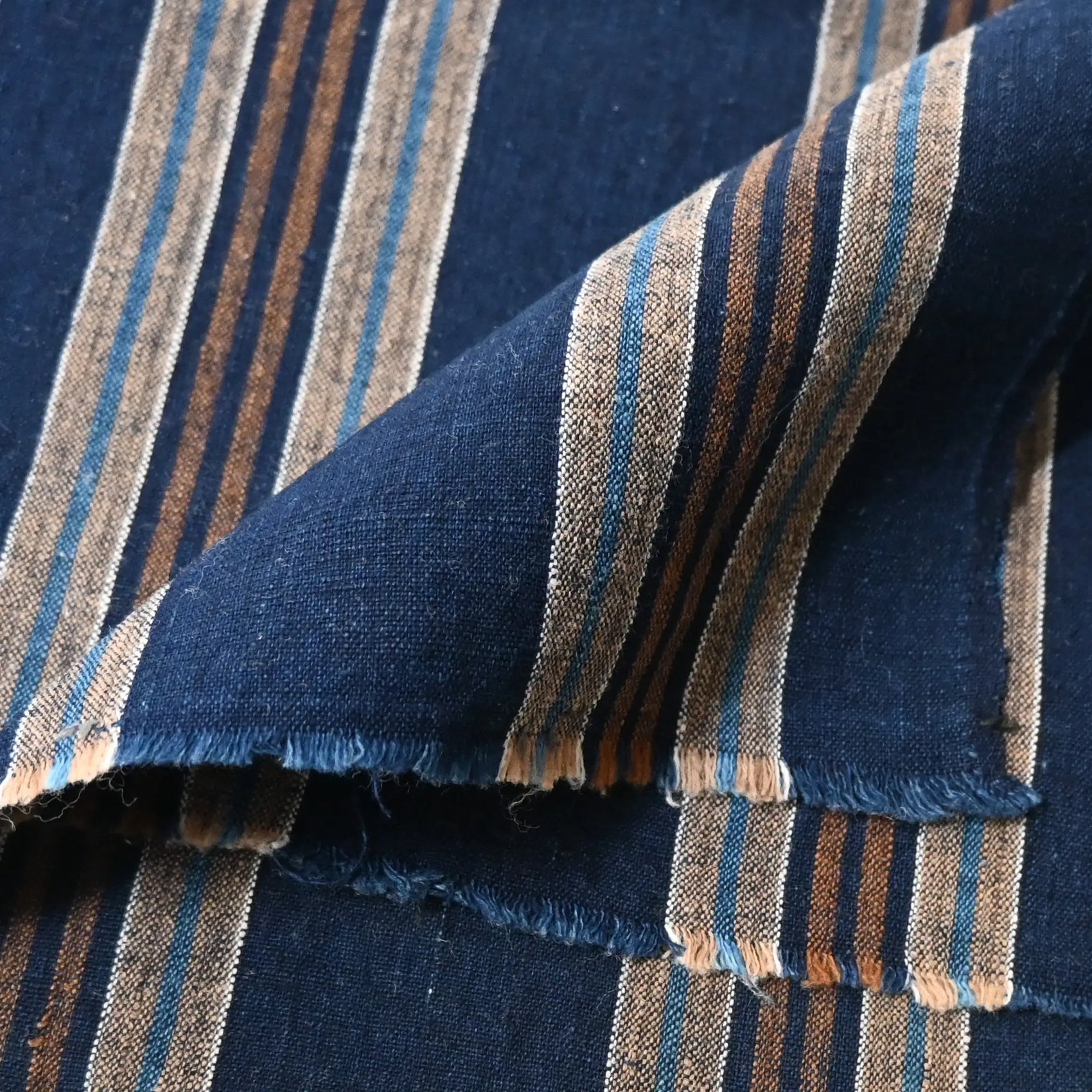 Close-up view of vintage Japanese indigo and warm brown stripe cotton piece from a futon cover, early 20th Century.