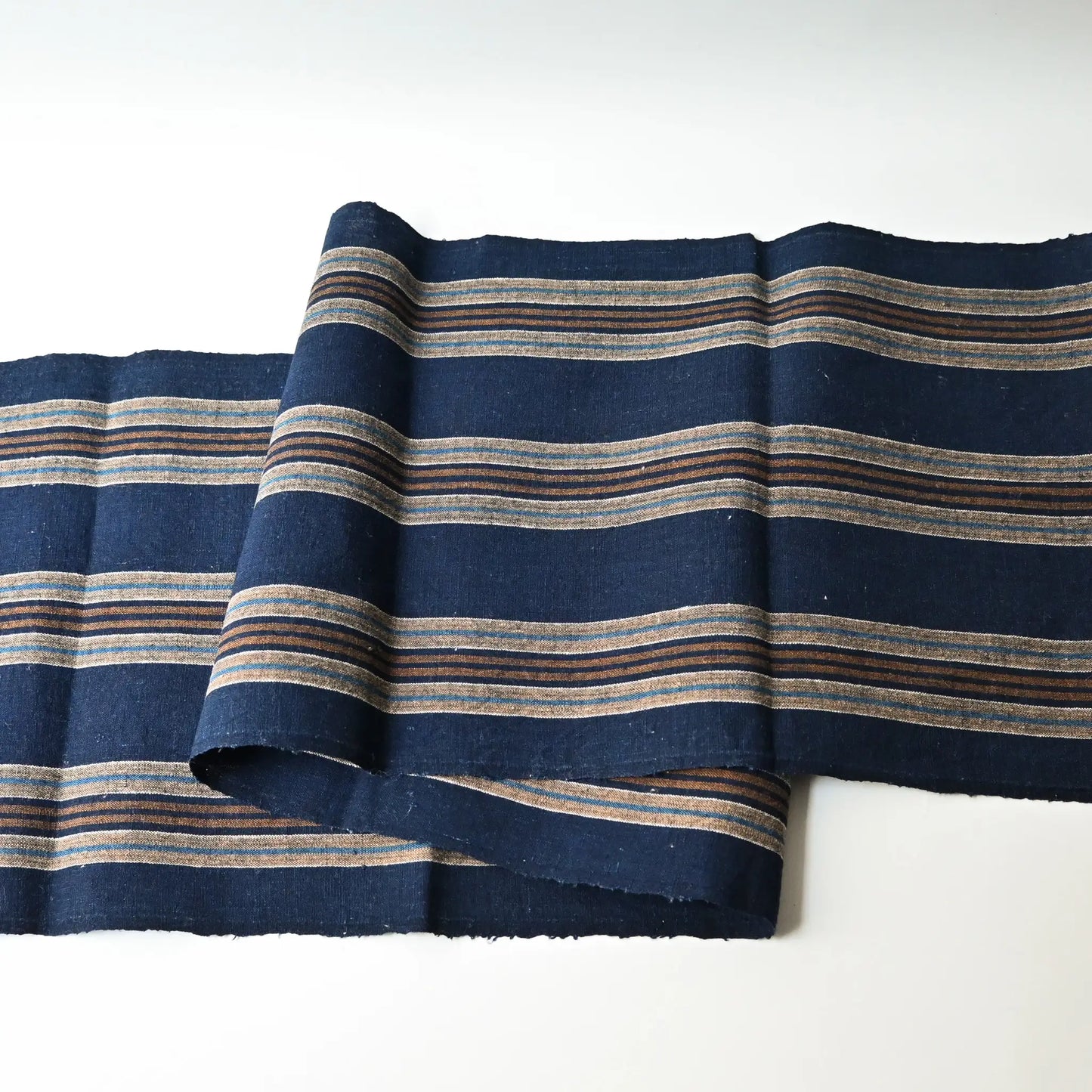 Full view of vintage Japanese indigo and warm brown stripe cotton piece from a futon cover, early 20th Century.