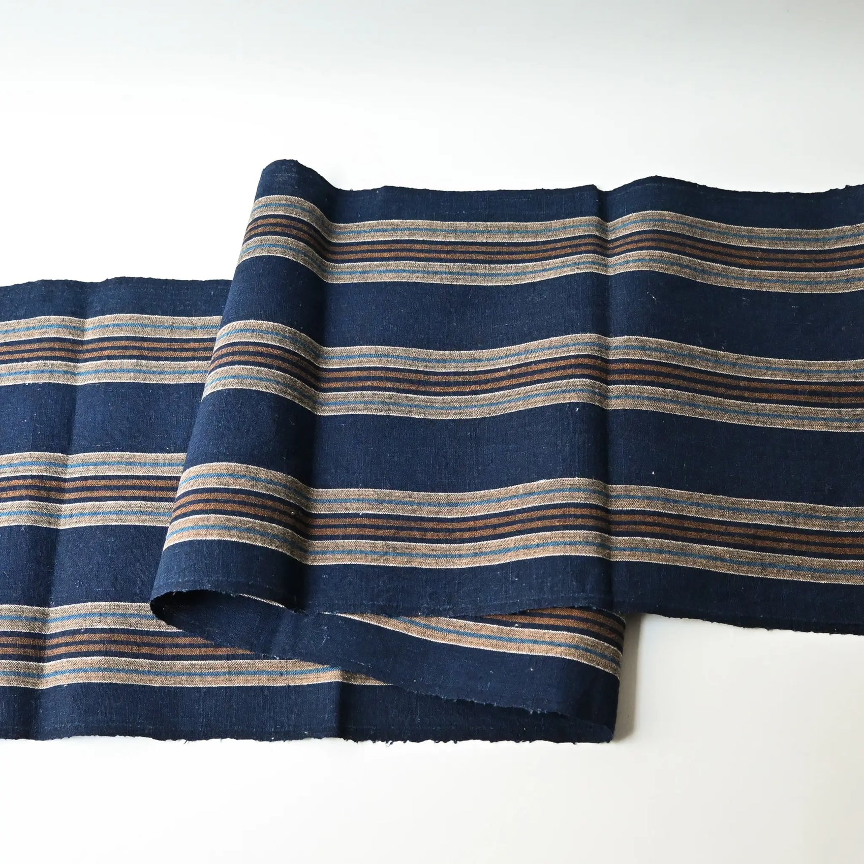 Full view of vintage Japanese indigo and warm brown stripe cotton piece from a futon cover, early 20th Century.