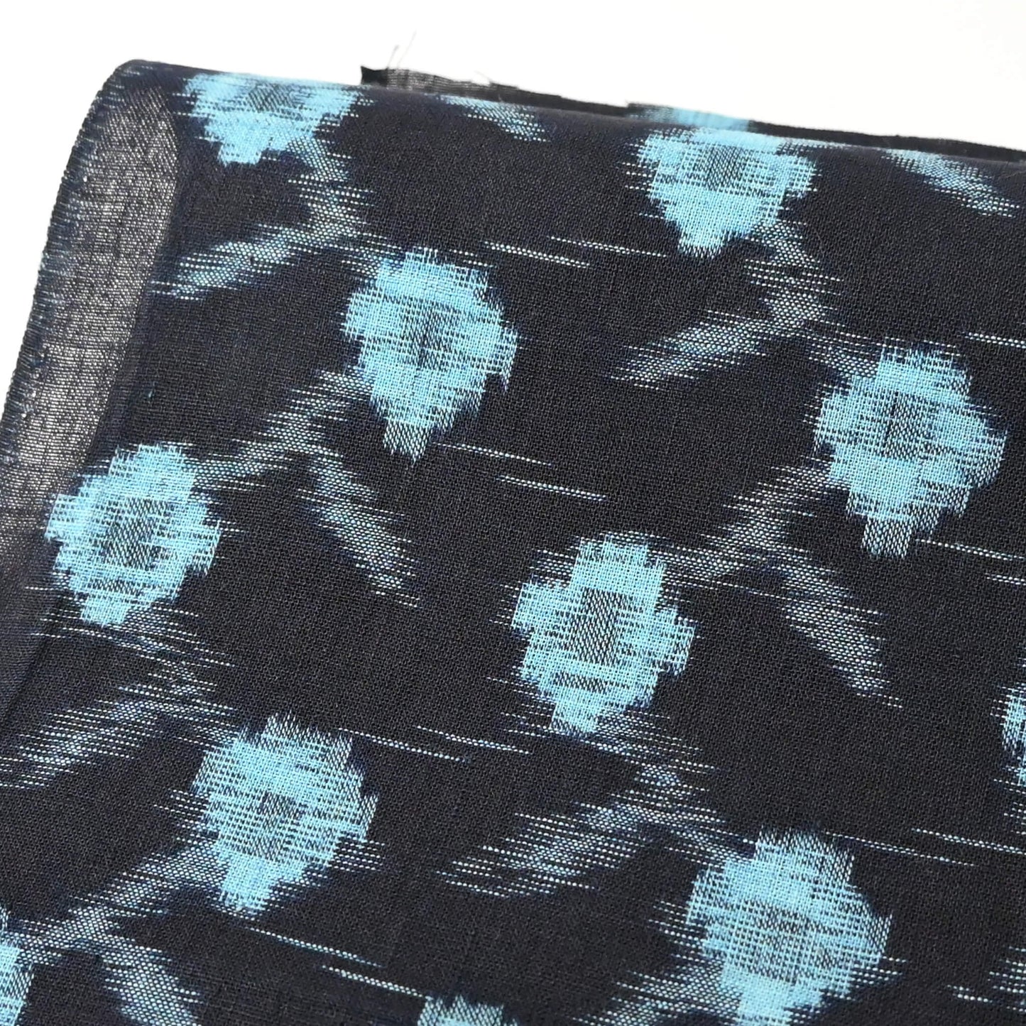 Close-up view of vintage indigo kasuri cotton kimono fabric piece.