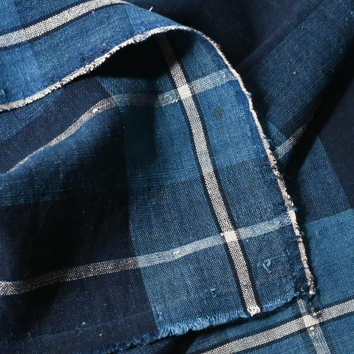 Close-up view of vintage Japanese indigo cotton futon cover panel with bold check pattern.