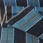 Close-up view of vintage indigo bold stripe cotton fabric piece, medium to heavy weight.