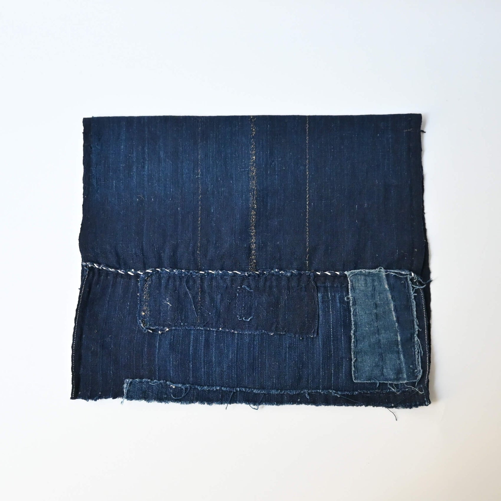 A fragment of Japanese  indigo boro piece from a futon cover.
