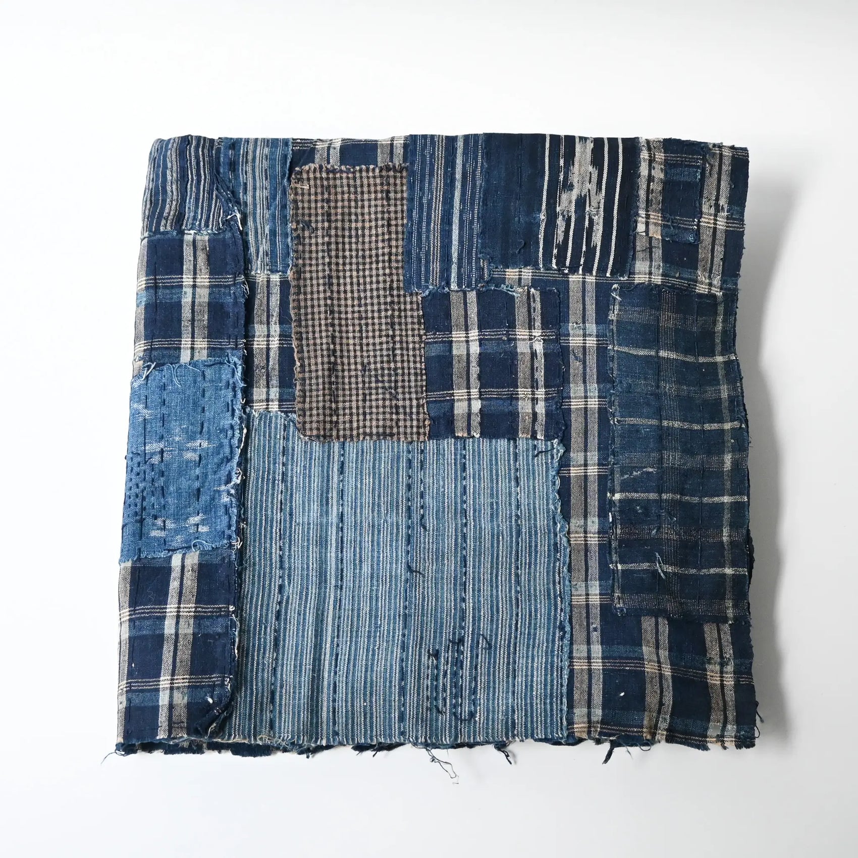 Vintage Japanese indigo check cotton Boro futon cover with layers of mending.