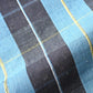 Detailed view of vintage Japanese hand loomed indigo check cotton piece, striking yet elegant pattern.