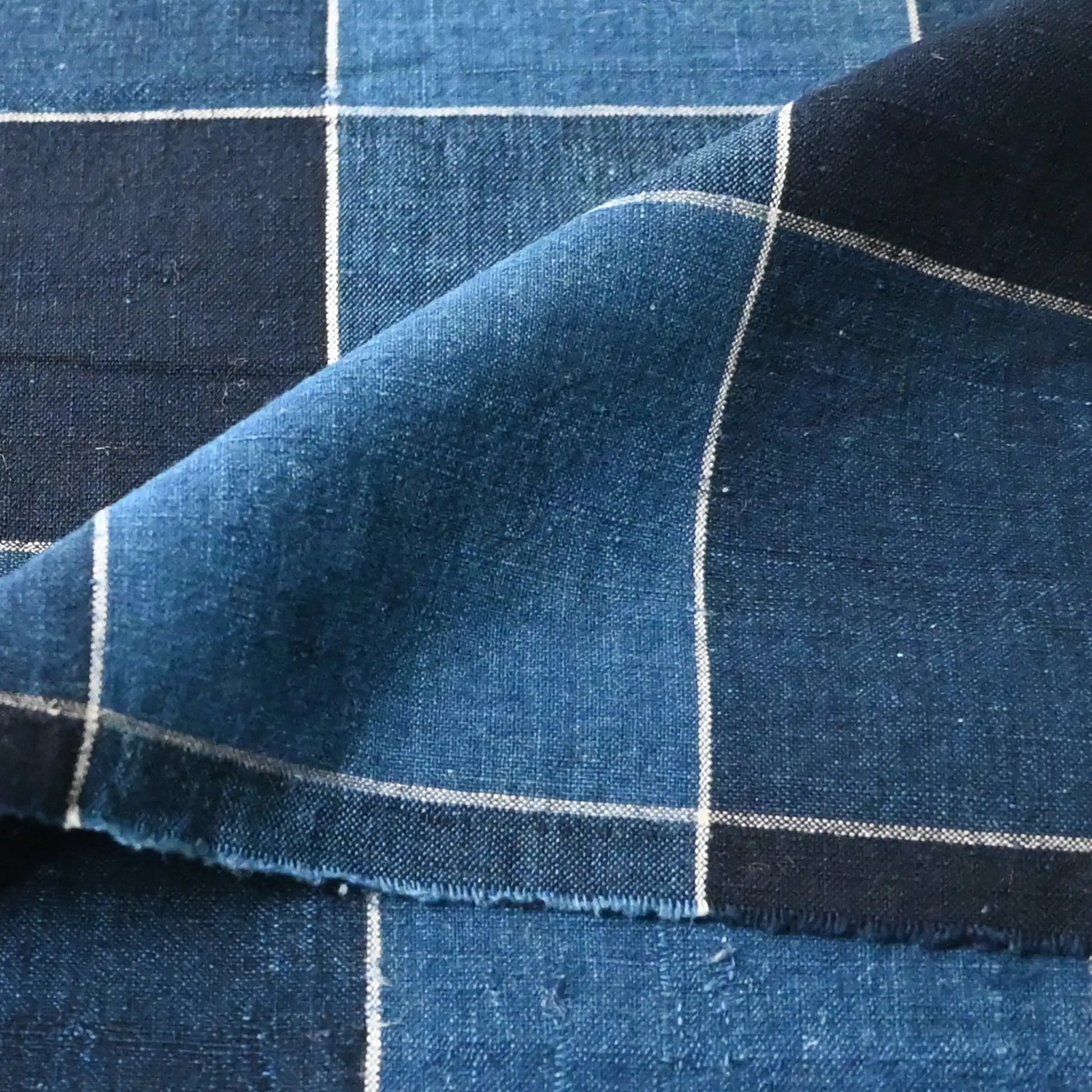Detailed view of vintage Japanese indigo check cotton futon cover panel with a bold grid pattern.