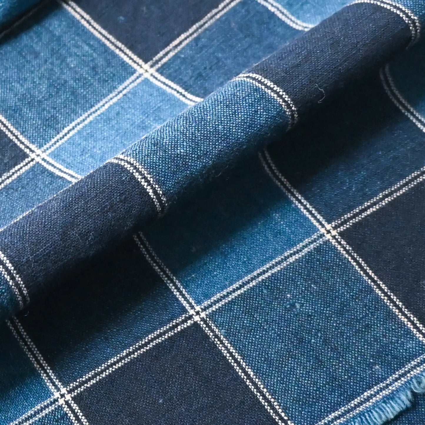 Detailed view of vintage indigo check cotton futon cover panel.