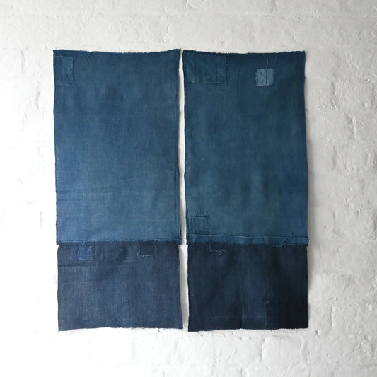 Two fragments of vintage indigo cotton kimono lining with charming hand-stitched mends.