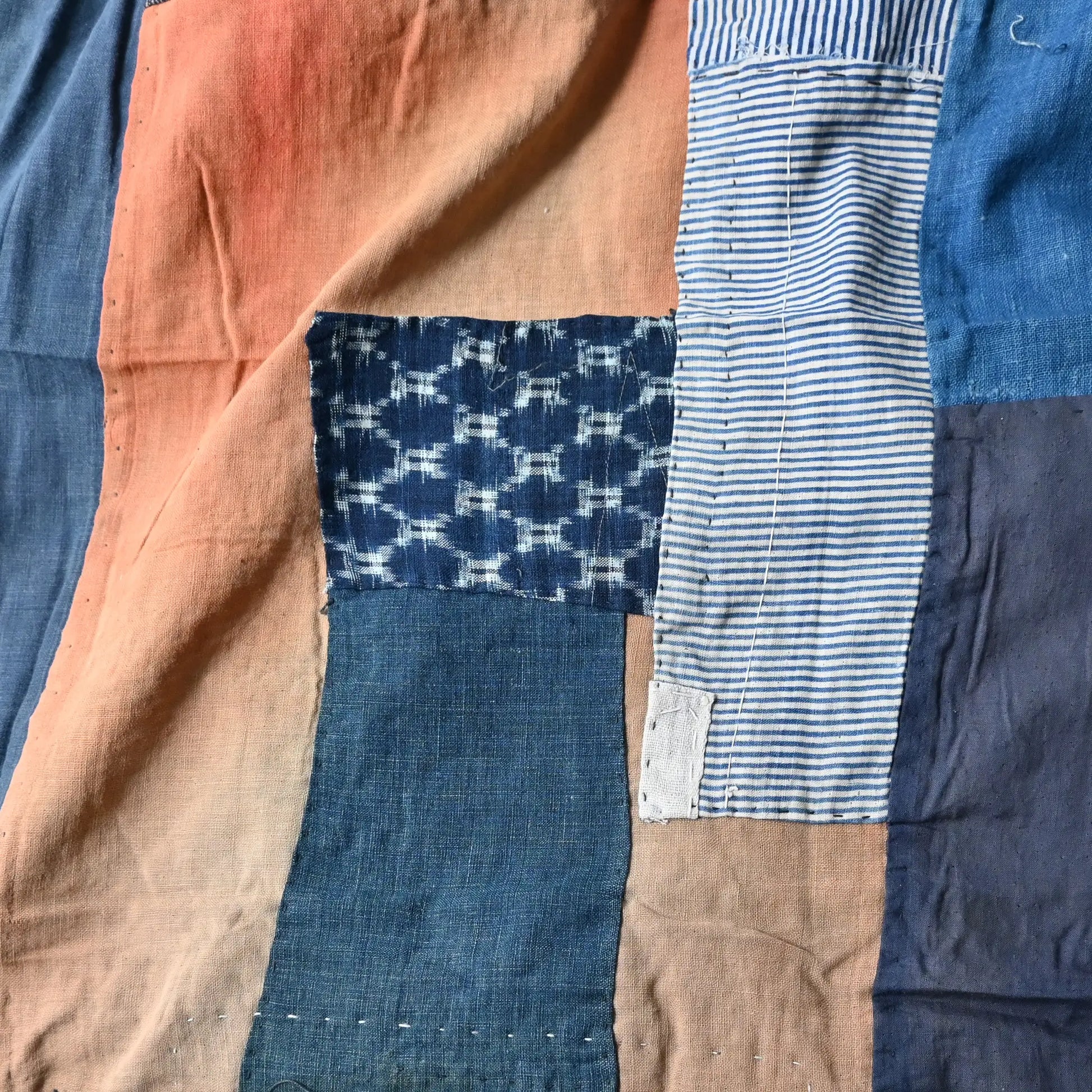 Detailed view of vintage futon cover made from a mix of various cottons recycled from kimono and kimono linings.