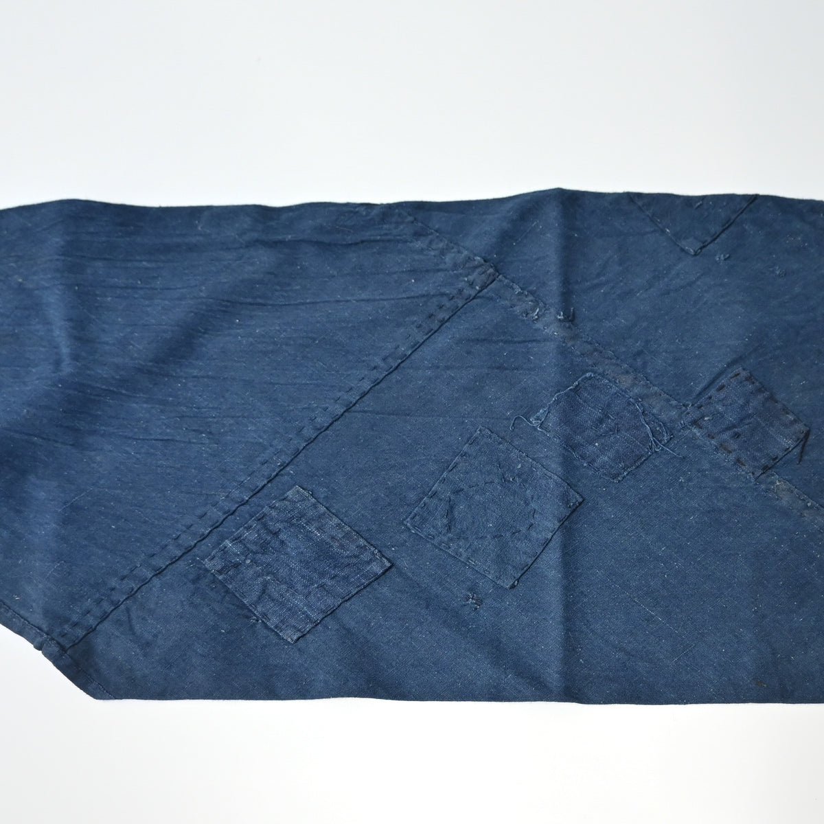 Detailed view of rare vintage indigo cotton tube cloth with mends.