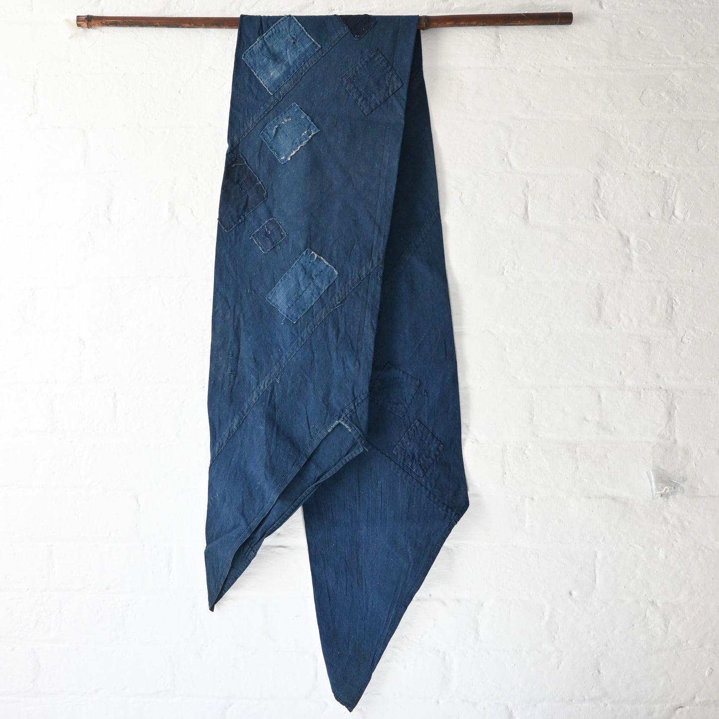Full view of rare vintage indigo cotton tube cloth with mends.