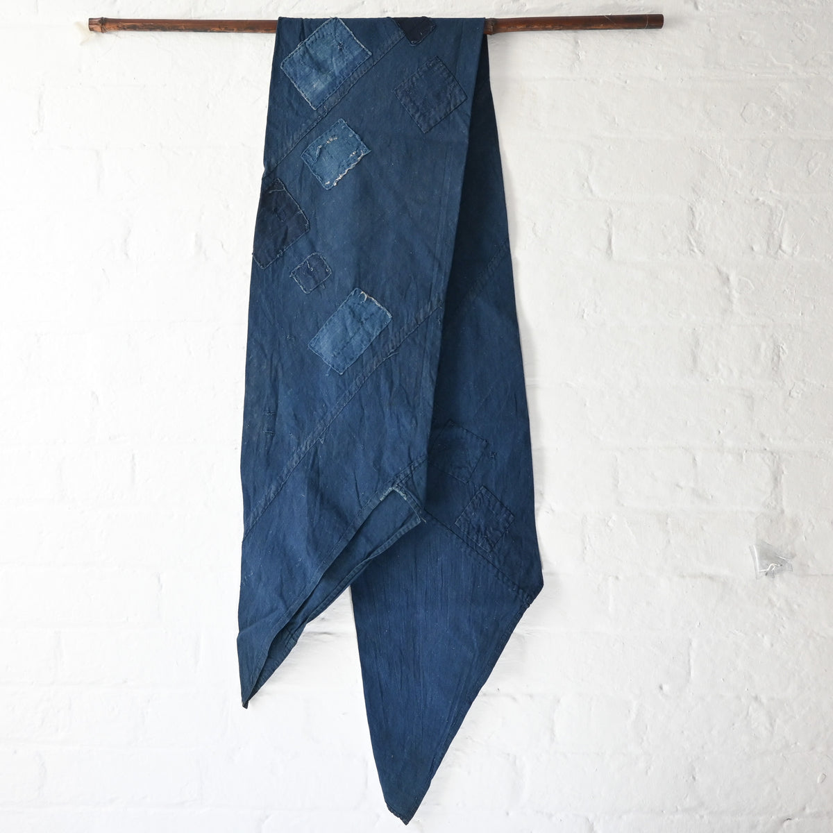 Full view of rare vintage indigo cotton tube cloth with mends.